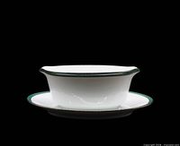 Front view of gravy boat attached to underplate showing shape and rim design