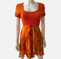 Front view of orange knit-top, button-front chiffon skirt dress on mannequin