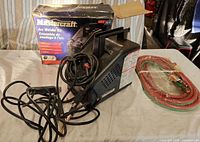Mastercraft arc welder, twin-line hose, original box on table