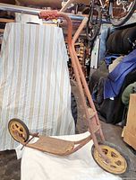 Full left-side view of scooter showing frame, wheels and handlebars