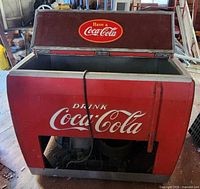 Front view of red Coca-Cola cooler with open lid