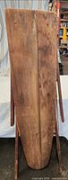 Top side of wooden ironing board standing folded