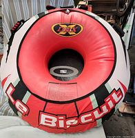 Front view of DBX Le Biscuit inflatable towable tube showing graphics and central opening