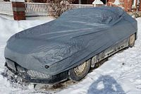 Car cover installed on compact sedan, front three-quarter view