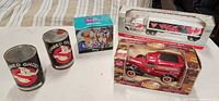 Lot overview showing both Canadian Tire vehicles, Pooh mug box, two Canned Ghost cans
