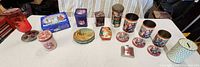 Group view of feeder, tins, flask, coasters on table