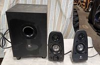 Subwoofer and two satellite speakers front view