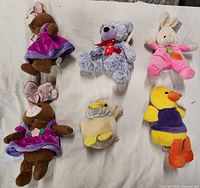 Group shot of all six plush toys laid on white background