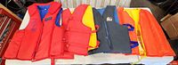 Front view of all four life jackets lined up