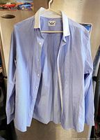 Full view of blue River Island dress shirt on hanger