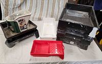 Overall group of paint trays and pail