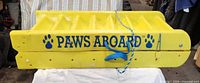 Folded ladder showing Paws Aboard branding and rope