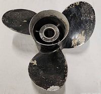 Front view of propeller showing three blades and hub opening