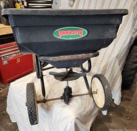 Front view showing Lawncrafter logo, hopper, wheels and frame