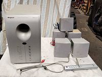 Front view of Regent subwoofer with five cube satellites and remote