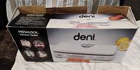 Retail box front showing Deni Freshlock Vacuum Sealer branding and imagery