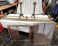 Overall lot showing pair of andirons, brass fender rail and brass screen track