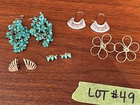 Group shot of all five earring pairs on wooden surface