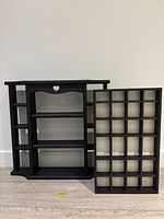 Both black wood shelves side by side