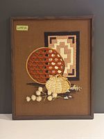 Front view of framed needlepoint artwork