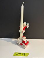 Full view of candle holder with Santa base, Mrs Claus hugger and taper candle