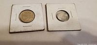 Front view of both coins in 2×2 holders
