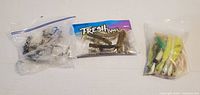 Overview of three bags/packages of fishing lures and tackle