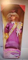 Front view of boxed 1991 Graduation Barbie doll showing sash and bouquet