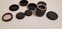 Teleconverter lens, UV filter, six assorted caps overview
