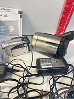 Both camcorders with AC adapter and cables visible