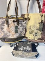 Group shot showing all three Myra Bag handbags with tags attached