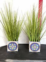 Two faux grass arrangements side by side for scale