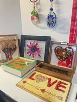 Group shot showing framed artworks, trays and LOVE plaque