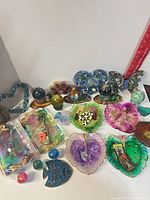 Group shot of all resin dishes, trays, spheres, butterfly, heart sculpture and hair clips