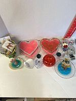 Group view of all resin trays, dishes, selenite hearts, red container and packaged earrings