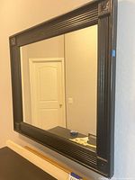 Front view of mirror showing frame design and intact glass