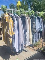 Rack showing approximately 15 assorted men’s shirts
