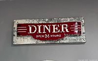 Front view of metal DINER sign showing design and text