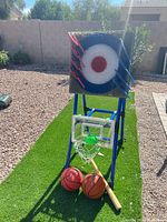 Full view of assembled stand with target panel, hoop, balls and axes