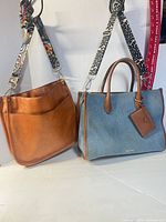 Nine West denim satchel and tan faux leather hobo side by side