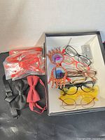 Overview of all eyewear and bow ties in box and adjacent, showing counts and styles