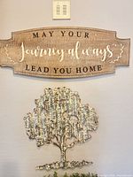 Wood sign and metal tree wall decor displayed together