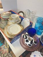 Overview of mixed dinnerware and glassware in box