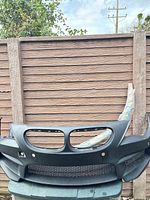 Full view of matte black BMW front bumper fascia on edge