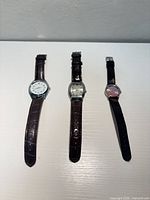 Three watches laid out side by side