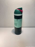 Full view of water bottle with label and closed flip lid