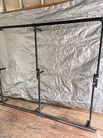 Full view of disassembled black steel bed frame