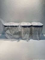 Front view of three clear plastic containers in original wrap