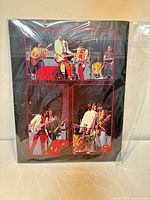 Front of poster folder sealed in plastic, showing four concert photos of The Rolling Stones