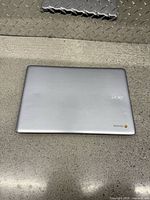 Closed silver Acer Chromebook showing top lid with Acer and Chrome logos